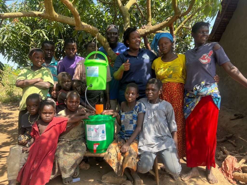 Lifewater Distribution in Kyaka II Refugee Settlement - happy recipients 3